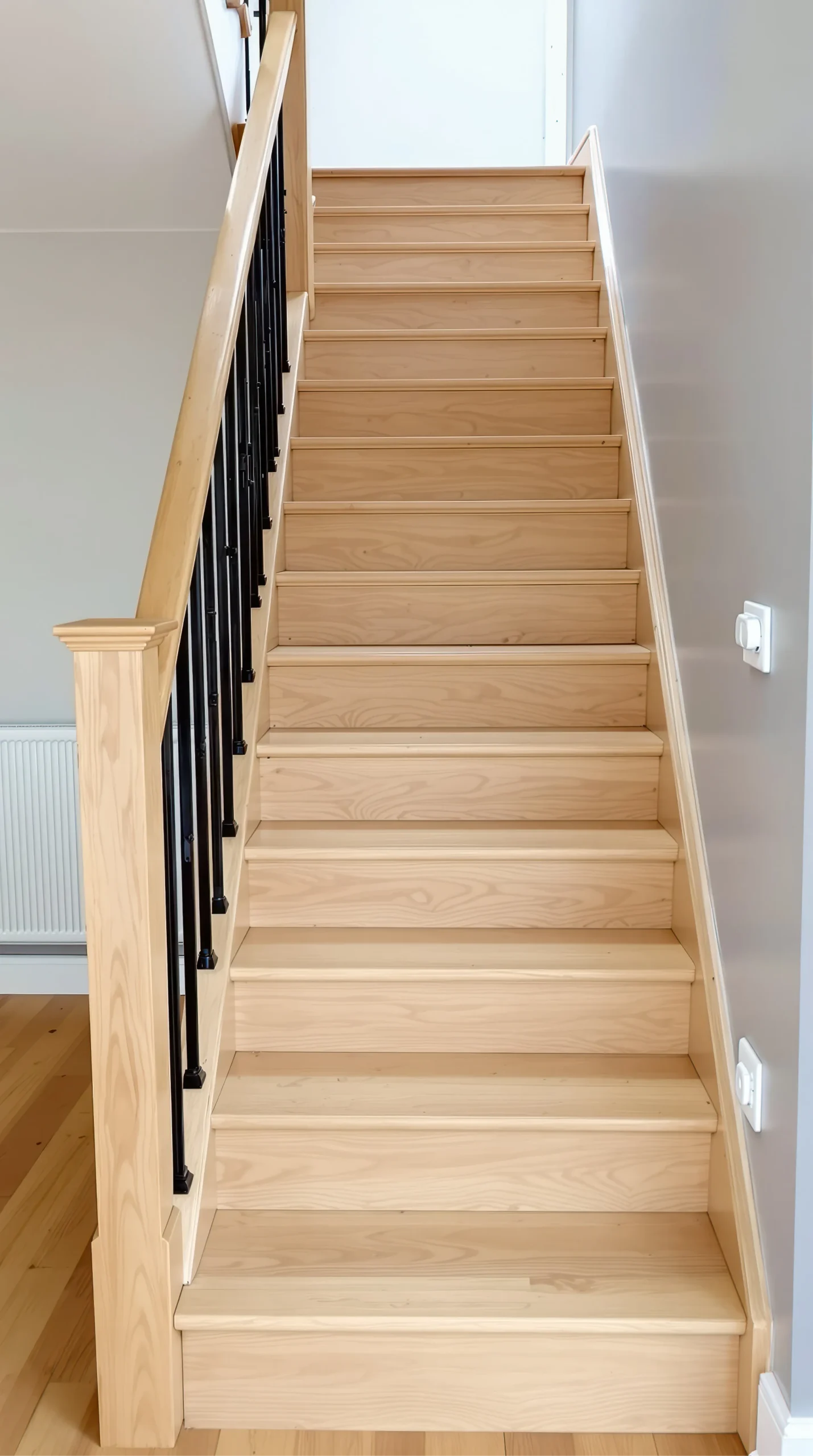 a clean interior staircase featuring light wood treads and risers this domestic flight of stairs and banister assembly shows a modern home staircase design photo 1